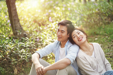 young asian couple relaxing in park