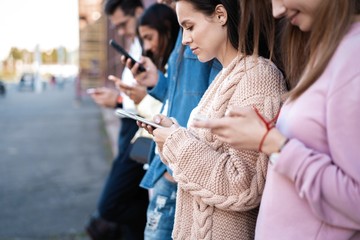 People standing with smartphones, reading messages, posts in social networks.