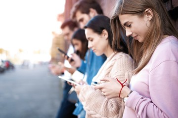 People standing with smartphones, reading messages, posts in social networks.