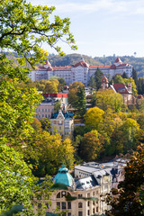 city views Karlovy Vary autumn. Czech Republic. Carlsbad. tree leaves in the foreground. Roofs of...