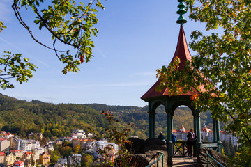 city views Karlovy Vary autumn. Czech Republic. Carlsbad. tree leaves in the foreground. Roofs...