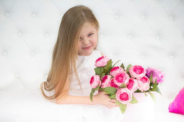 Beautiful child girl with flowers.