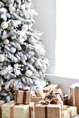 Gifts under the Christmas tree. Christmas background. Christmas tree decorated in white