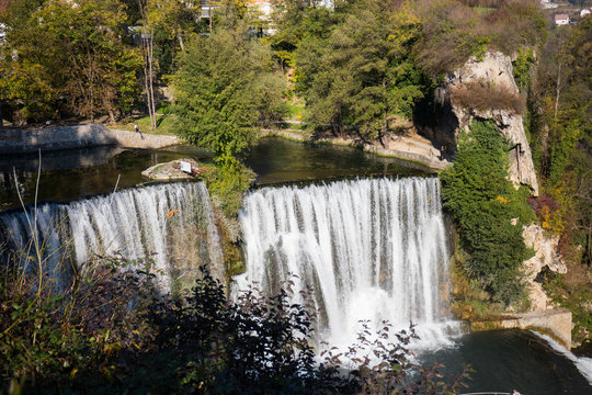 waterfall in beautiful nature with crystal clear water on wild river  in bosnia and herzegovina at sunny summer day