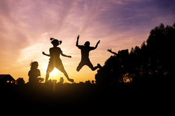 silhouette of lifestyle children active playing up hands and jumping joy on summer - 305427027