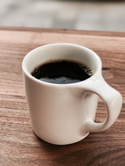 cup of coffee on wooden table