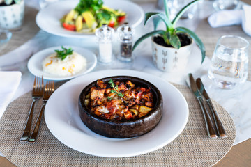 A delicious spicy chicken casserole with rice is served in a elegance restaurant or hotel