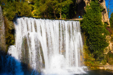 waterfall in beautiful nature with crystal clear water on wild river  in bosnia and herzegovina at sunny summer day