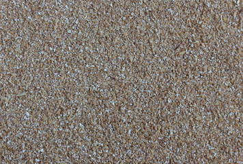 Crushed wheat groats as background, top view