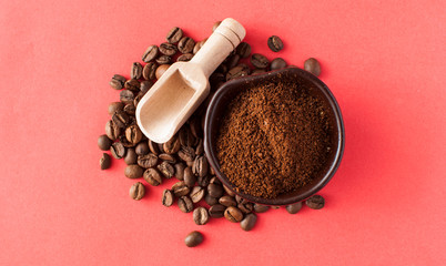 Closeup of a cup of ground coffee on the heap of roasted coffee beans, shot in the studio