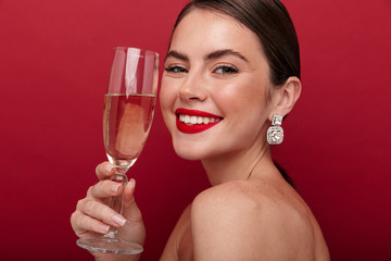 Happy woman holding glass with champagne or wine.