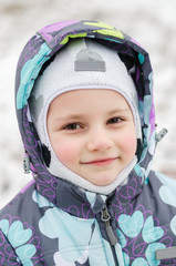 Portrait of a child girl on a winter park. child girl with Christmas candies in hands on a winter street