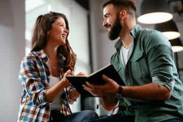Colleagues in office. Businesswoman and businessman discussing work in office. Two friends in working together.