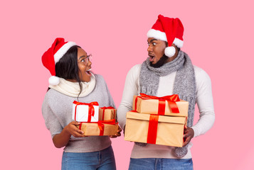 Christmas man and woman with gifts looking at each other