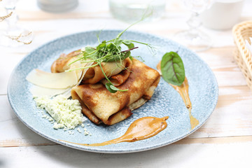 Pancakes with filling, fried appetizing pancakes stuffed with stuffing.