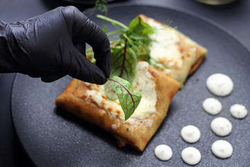  The chef decorates the plate. Serving and decorating the dish.