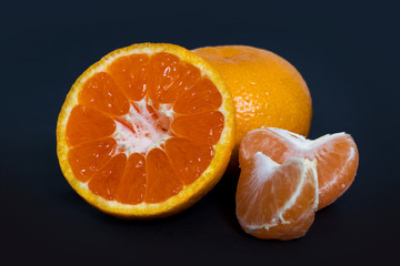 Fototapeta na wymiar juice tangerine fruit on a black background