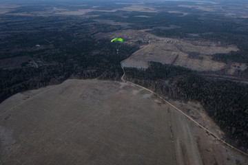Fototapeta na wymiar Skydiving. A parachute is in the sky above field.