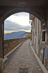 Fototapeta na wymiar Fornelli, 11/23/2019. A narrow street among the old houses of a mountain village in the Molise region