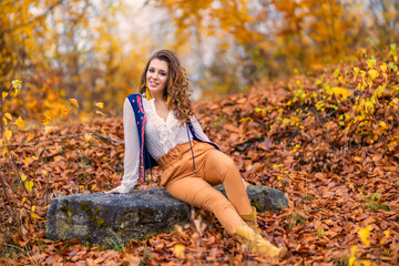 Portrait of a beautiful woman in autumn landscape