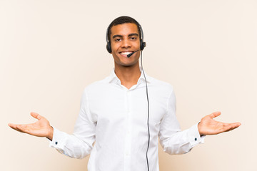 Young brunette man working with a headset with shocked facial expression