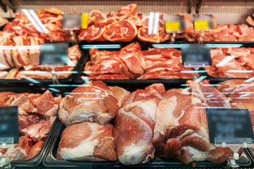 Selection of quality meat at a butcher shop, refrigerated display in the supermarket