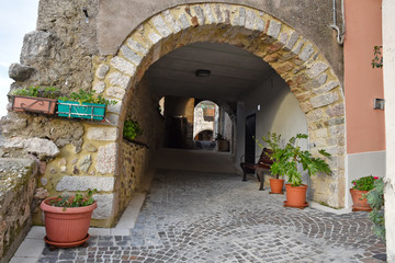 Fototapeta na wymiar Fornelli, 11/23/2019. A narrow street among the old houses of a mountain village in the Molise region
