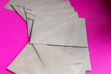 Kraft paper envelopes on a purple background. Perfect for mail, invitations, card, message decorations. Free space for text