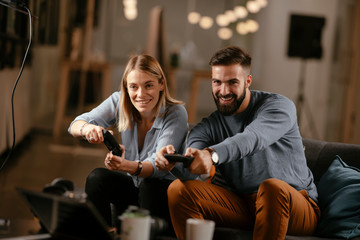 Happy young couple. Couple playing video game. 