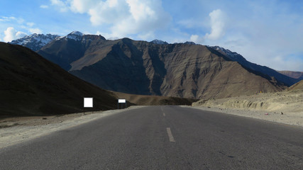 road in the mountains with sign board 
