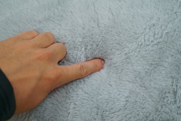Hand to check the softness of the cushion