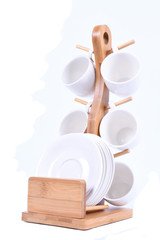 White coffee cups on wooden bamboo stand isolated on white background