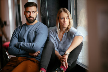 Young unhappy couple. Sad boyfriend and girlfriend. 