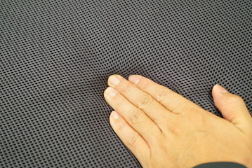 Hand to check the softness of the cushion