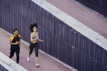 Fototapeta na wymiar latin young woman and black sports man running