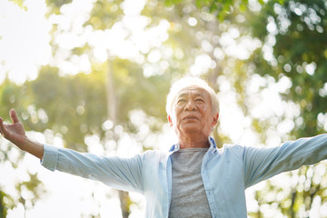 asian old man enjoying fresh air in park