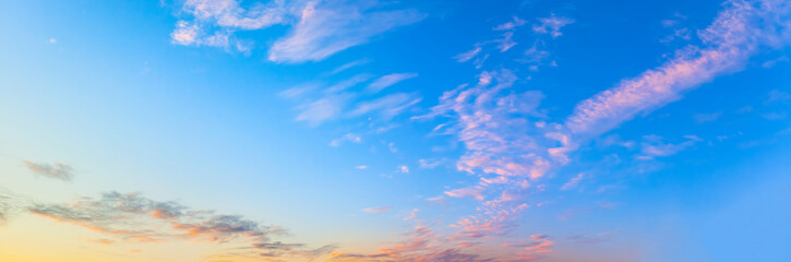 Panorama of beautiful sunset sky with clouds in windy day.