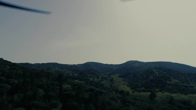 Propellers in action over the forest and hill in Canyamars, Catalonia, Spain