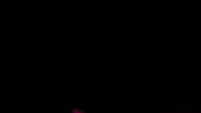 Electric guitar being rocked under flashing stobe lights. Shot in slow-motion.