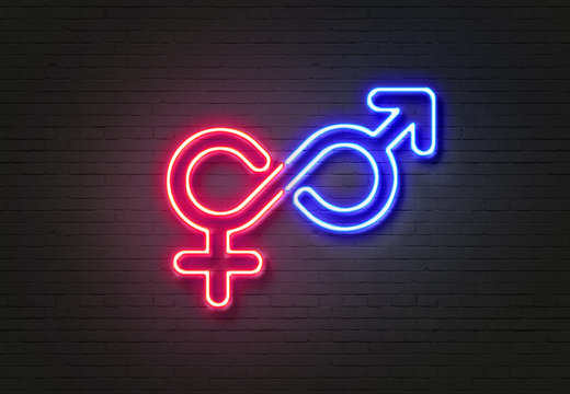 Male and female symbols on blue and pink neon signs