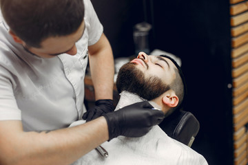 Obraz na płótnie Canvas Man with a beard. Hairdresser with a client.