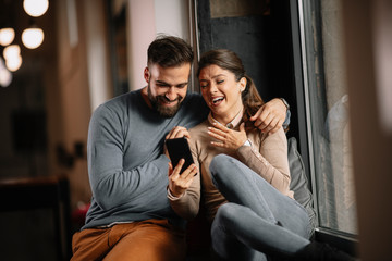 Young happy couple. Partners talking with friends on video call. 