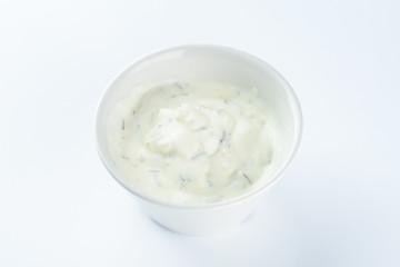 cream sauce with pickles in a bowl on a light background, mayonnaise