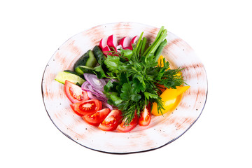 Vegetables cut with greens on a plate