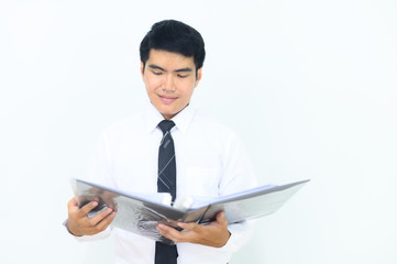 Young Asian businessman inspecting his document.