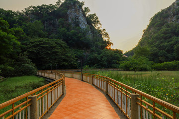 The walk way on the river go to nature mountain before sunset at thailand
