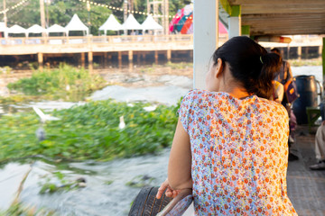 The woman sitting back on the boat