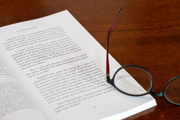 book and glasses on table