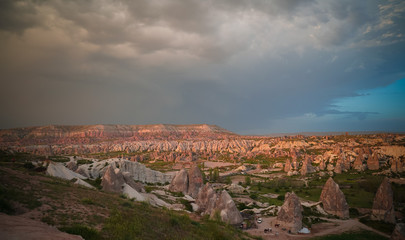 Fototapeta na wymiar Sunset panoramic view to Goreme city and valleys, Cappadocia, Turkey