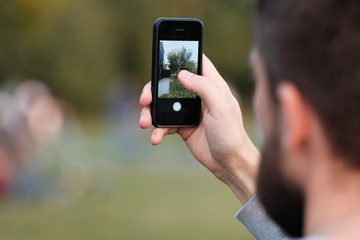 male hand holds the phone. mobile photography.